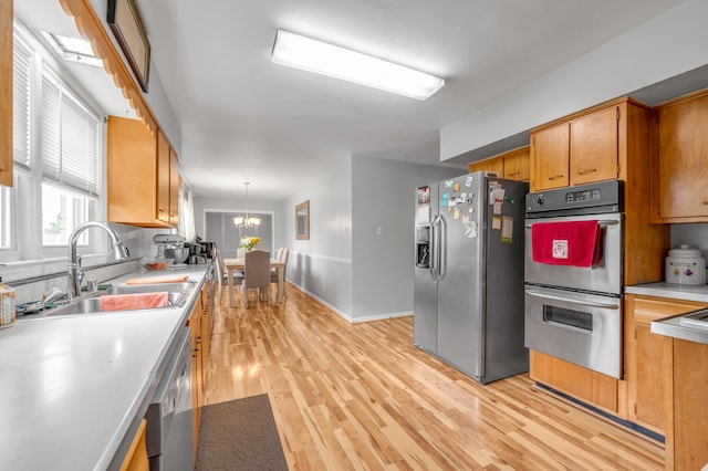 900 Shoshoni Trl, Georgetown, KY 40324 - kitchen with appliances with stainless steel finishes, a sink, light countertops, light wood-type flooring, and plenty of natural light