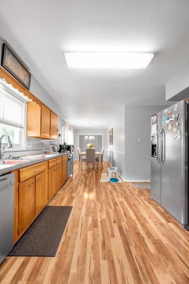 900 Shoshoni Trl, Georgetown, KY 40324 - kitchen featuring stainless steel appliances, light wood-style flooring, light countertops, and hanging light fixtures