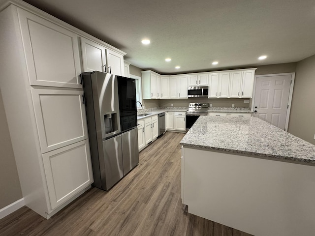 83 Gene Conner Rd, Russell Springs, KY 42642 - kitchen with stainless steel appliances, a sink, a center island, wood finished floors, and recessed lighting