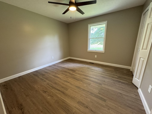 83 Gene Conner Rd, Russell Springs, KY 42642 - unfurnished bedroom featuring dark wood finished floors, baseboards, and ceiling fan