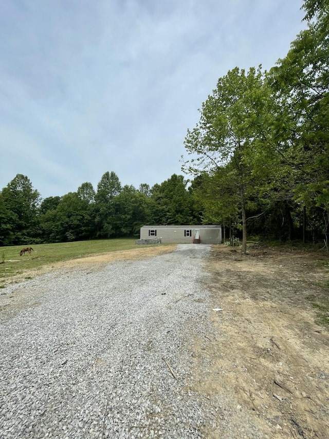 920 Barton Mill Cutoff Rd, Corbin, KY 40701 - view of front of house with gravel driveway and a wooded view