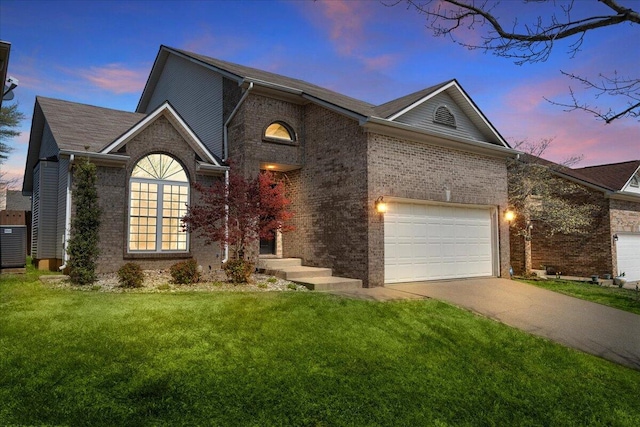 253 Gateway Park Cir, Lexington, KY 40511 - view of front of house featuring concrete driveway, brick siding, a lawn, and an attached garage