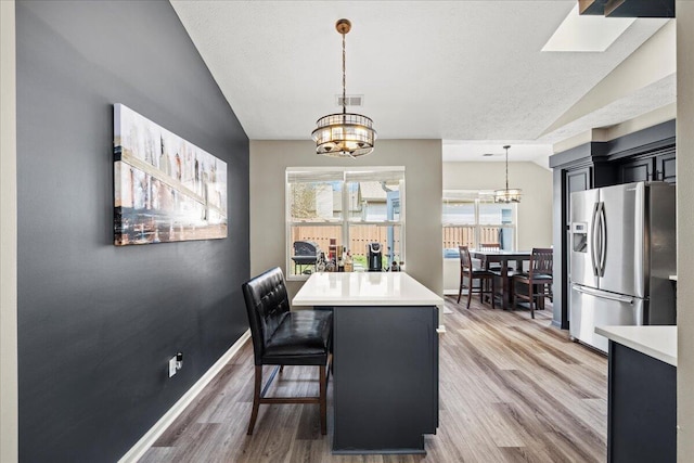 253 Gateway Park Cir, Lexington, KY 40511 - dining space featuring a chandelier, lofted ceiling, light wood-style floors, and baseboards