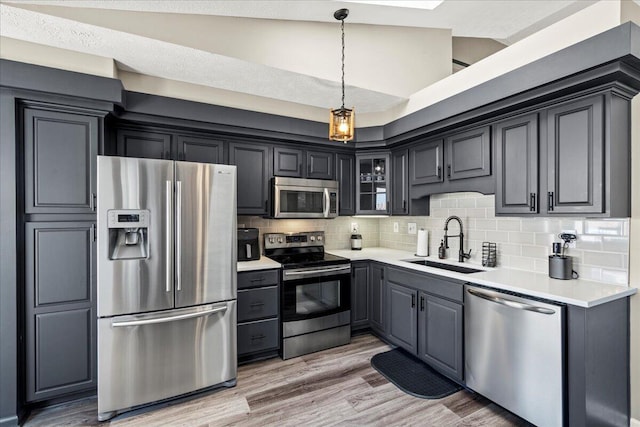 253 Gateway Park Cir, Lexington, KY 40511 - kitchen with appliances with stainless steel finishes, a sink, decorative backsplash, glass insert cabinets, and light countertops