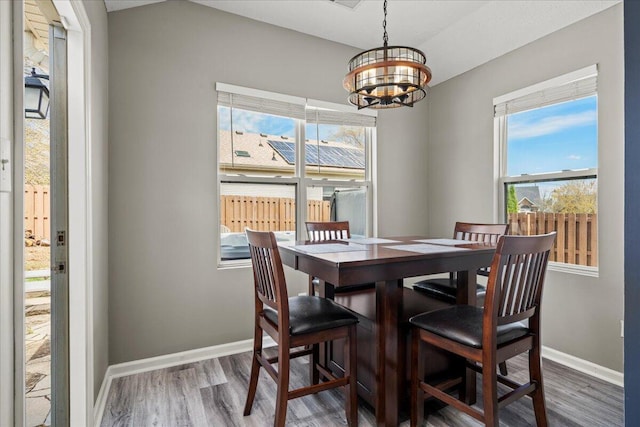 253 Gateway Park Cir, Lexington, KY 40511 - dining room with wood finished floors, a chandelier, baseboards, and healthy amount of natural light