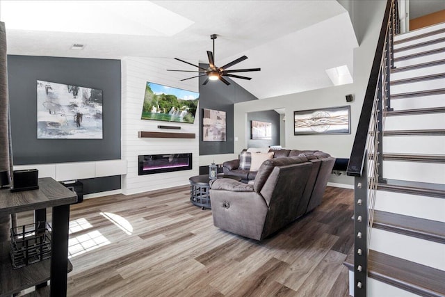 253 Gateway Park Cir, Lexington, KY 40511 - living area with a skylight, wood finished floors, vaulted ceiling, stairs, and a large fireplace