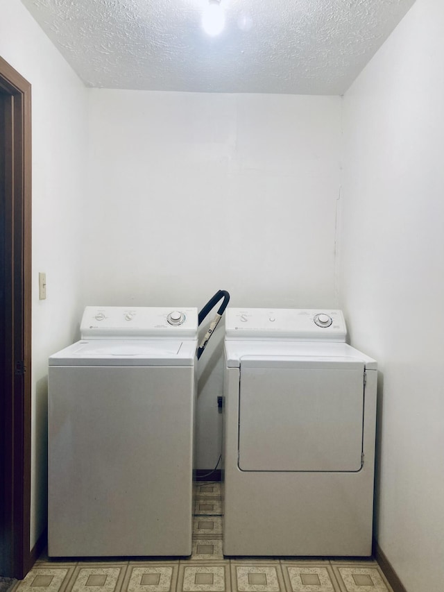1184 Snow Creek Rd, Clay City, KY 40312 - laundry room featuring washer and clothes dryer, light flooring, and a textured ceiling
