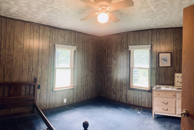 1184 Snow Creek Rd, Clay City, KY 40312 - unfurnished bedroom with carpet, wood walls, and ceiling fan