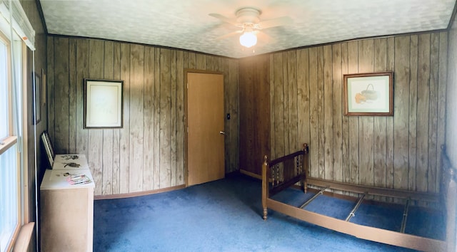 1184 Snow Creek Rd, Clay City, KY 40312 - unfurnished bedroom featuring wooden walls, carpet, a textured ceiling, a ceiling fan, and baseboards