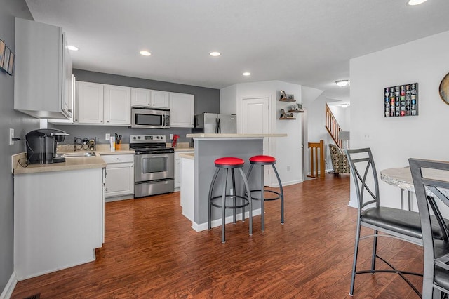 2433 Aristocracy Cir, Lexington, KY 40509 - kitchen with appliances with stainless steel finishes, light countertops, a breakfast bar, white cabinets, and recessed lighting