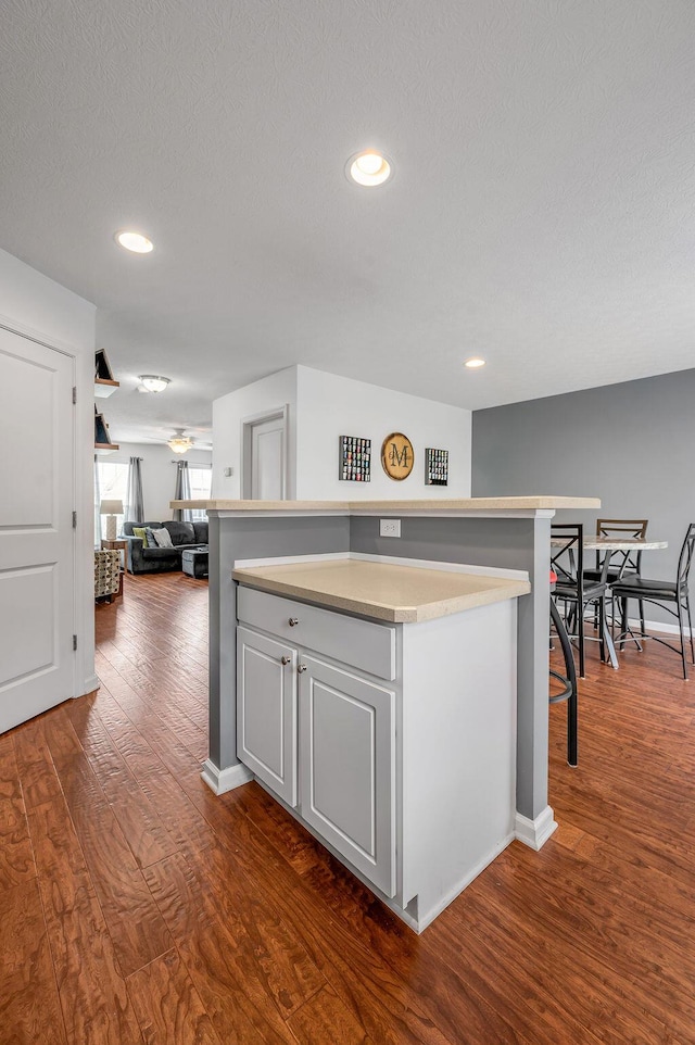 2433 Aristocracy Cir, Lexington, KY 40509 - kitchen featuring dark wood-style floors, a kitchen island, light countertops, recessed lighting, and open floor plan
