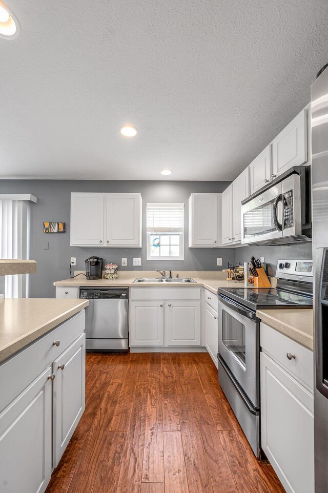 2433 Aristocracy Cir, Lexington, KY 40509 - kitchen with appliances with stainless steel finishes, a sink, dark wood-type flooring, white cabinets, and recessed lighting