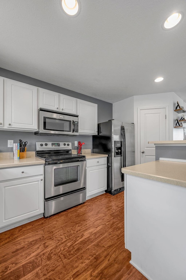 2433 Aristocracy Cir, Lexington, KY 40509 - kitchen featuring stainless steel appliances, white cabinets, light countertops, wood finished floors, and recessed lighting
