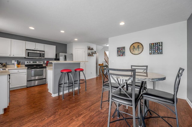 2433 Aristocracy Cir, Lexington, KY 40509 - kitchen featuring appliances with stainless steel finishes, a kitchen breakfast bar, white cabinetry, a center island, and recessed lighting