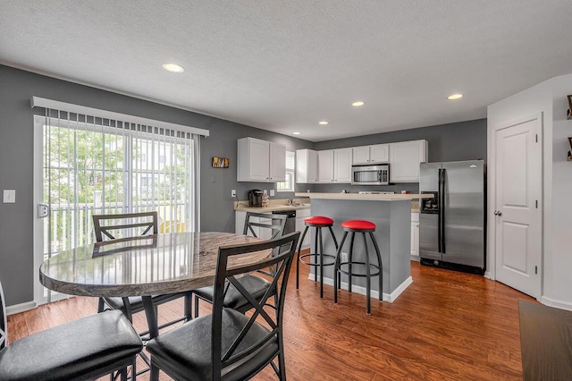 2433 Aristocracy Cir, Lexington, KY 40509 - dining area with dark wood finished floors, recessed lighting, baseboards, and a textured ceiling