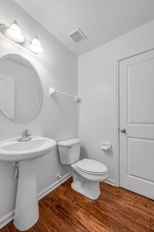 2433 Aristocracy Cir, Lexington, KY 40509 - bathroom featuring toilet, wood finished floors, baseboards, a textured ceiling, and a sink