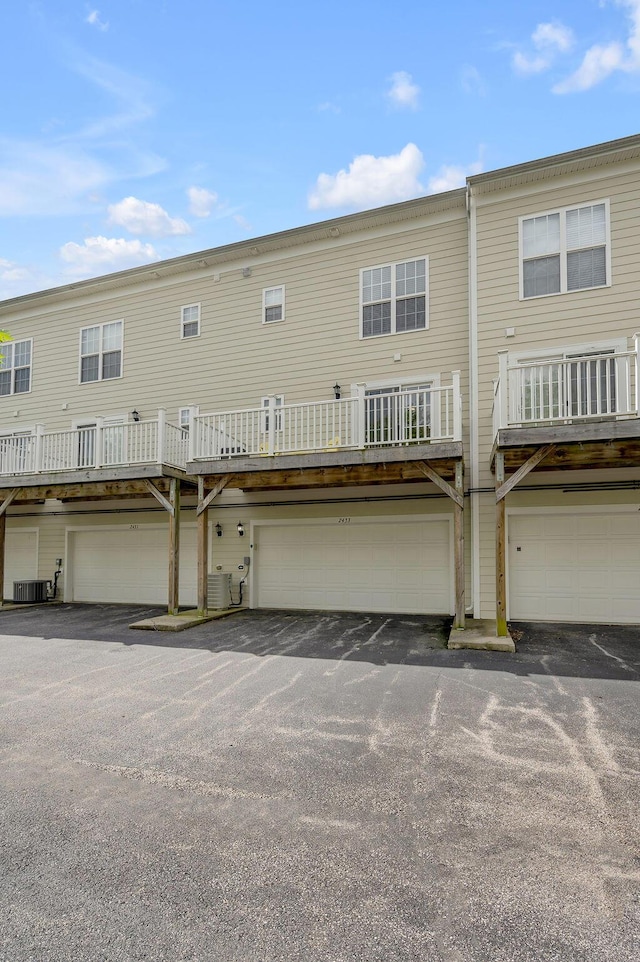 2433 Aristocracy Cir, Lexington, KY 40509 - back of property featuring an attached garage and central AC unit