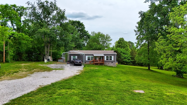1126 College Hill Rd, Waco, KY 40385 - view of front of home with driveway, a carport, a wooden deck, and a front lawn