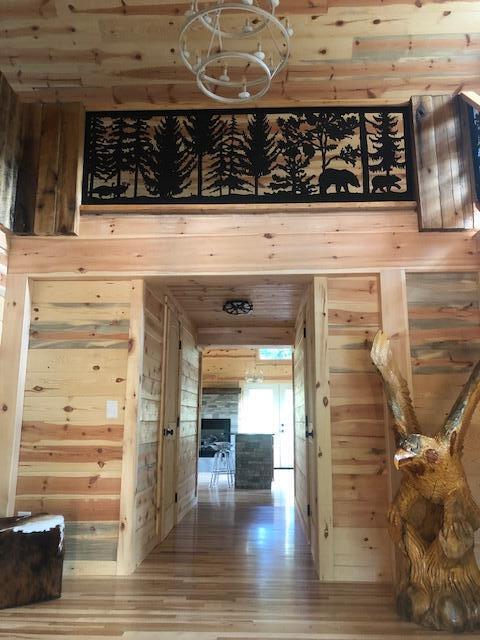 616 Zag Rd, West Liberty, KY 41472 - hallway with wooden walls and wood finished floors