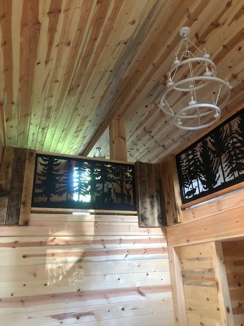 616 Zag Rd, West Liberty, KY 41472 - detailed view of a chandelier, wooden walls, and wooden ceiling