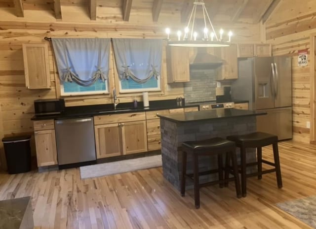 616 Zag Rd, West Liberty, KY 41472 - kitchen with appliances with stainless steel finishes, dark countertops, a sink, wood walls, and light wood-style floors