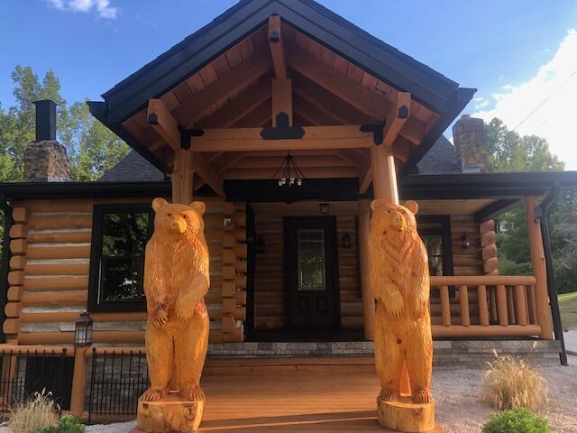 616 Zag Rd, West Liberty, KY 41472 - doorway to property featuring log siding, a chimney, and covered porch