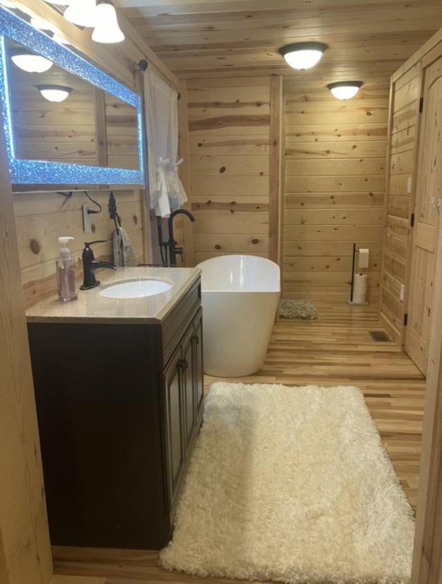 616 Zag Rd, West Liberty, KY 41472 - bathroom with vanity, a freestanding tub, wood walls, wood finished floors, and wood ceiling
