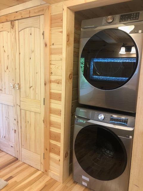 616 Zag Rd, West Liberty, KY 41472 - laundry area with stacked washer / dryer and wood finished floors