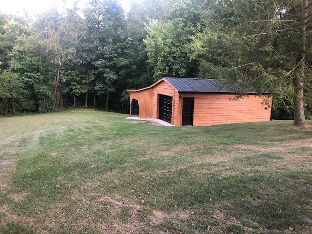 616 Zag Rd, West Liberty, KY 41472 - view of green lawn featuring an outbuilding and a view of trees