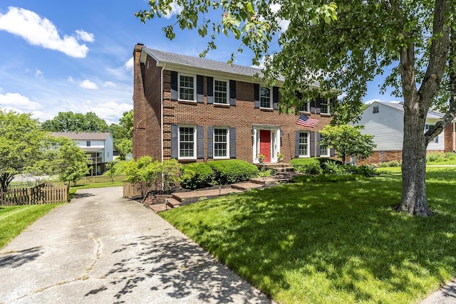 1025 Stowbridge Ln, Lexington, KY 40515 - colonial home with a chimney, brick siding, and driveway
