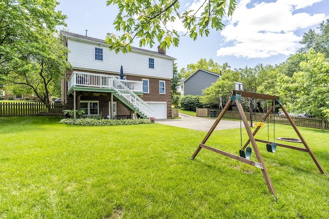 1025 Stowbridge Ln, Lexington, KY 40515 - back of house featuring stairway, brick siding, a playground, concrete driveway, and an attached garage