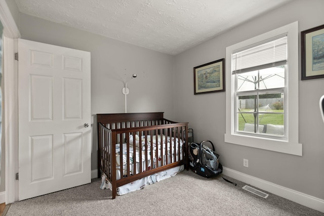 304 Hamilton Ave, Somerset, KY 42501 - carpeted bedroom featuring a textured ceiling, baseboards, and a nursery area