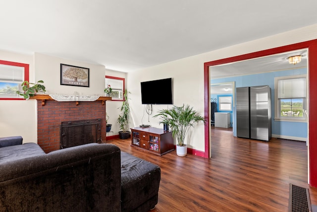 10165 Clifton Rd, Versailles, KY 40383 - living room featuring wood finished floors, baseboards, and a brick fireplace