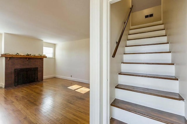 10165 Clifton Rd, Versailles, KY 40383 - stairway with wood finished floors, a fireplace, and baseboards