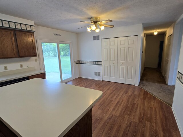 110 Albany Ln, Winchester, KY 40391 - kitchen featuring light countertops, dark wood-style flooring, a ceiling fan, dark brown cabinetry, and a textured ceiling