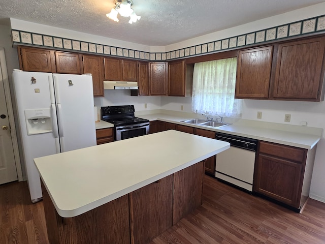 110 Albany Ln, Winchester, KY 40391 - kitchen with white appliances, under cabinet range hood, a sink, dark wood-style floors, and a textured ceiling