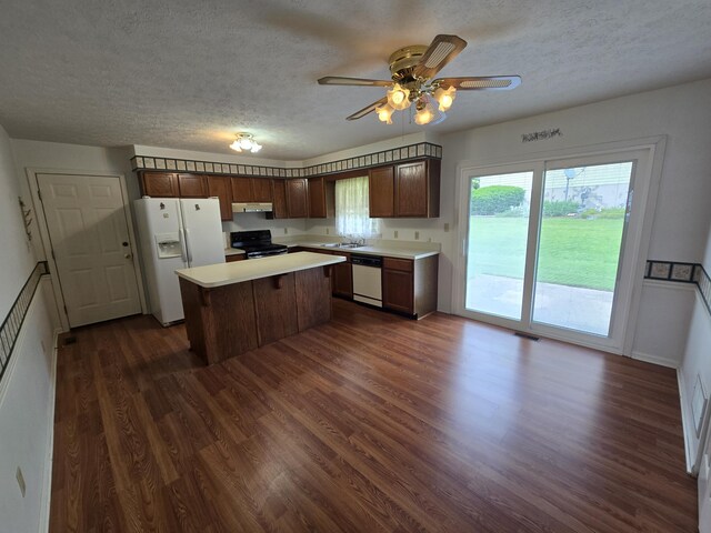 110 Albany Ln, Winchester, KY 40391 - kitchen with white appliances, a textured ceiling, dark wood finished floors, a sink, and light countertops