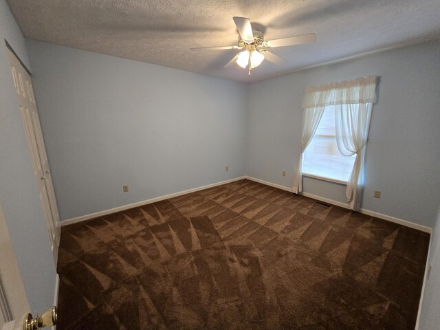 110 Albany Ln, Winchester, KY 40391 - unfurnished bedroom with dark colored carpet, a textured ceiling, baseboards, and ceiling fan