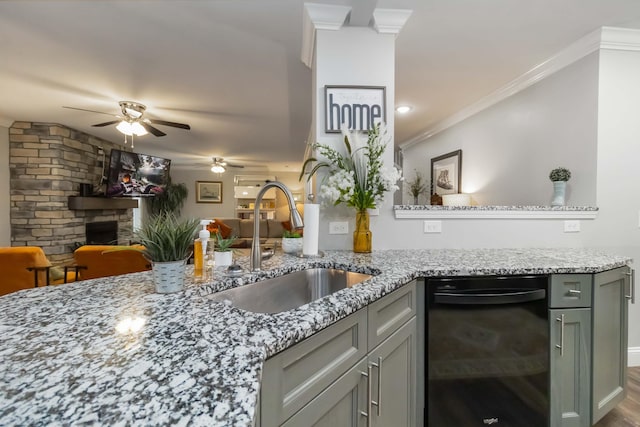 2002 Emerald Way, Richmond, KY 40475 - kitchen featuring black dishwasher, a sink, a fireplace, ceiling fan, and light stone countertops