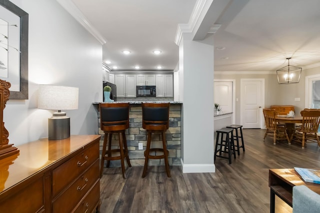 2002 Emerald Way, Richmond, KY 40475 - kitchen featuring black appliances, a breakfast bar area, dark wood-type flooring, ornamental molding, and recessed lighting