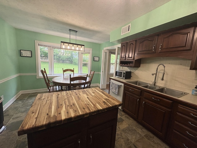 524 Cromwell Way, Lexington, KY 40503 - kitchen featuring wood counters, a sink, tasteful backsplash, appliances with stainless steel finishes, and dark brown cabinets
