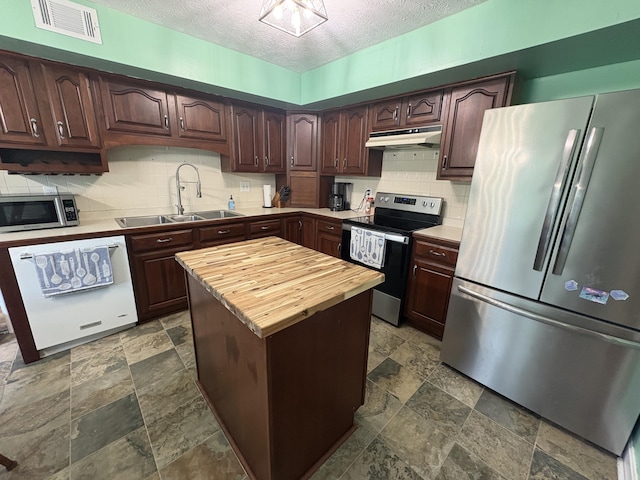 524 Cromwell Way, Lexington, KY 40503 - kitchen with appliances with stainless steel finishes, a sink, butcher block countertops, stone finish flooring, and decorative backsplash