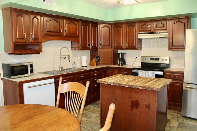524 Cromwell Way, Lexington, KY 40503 - kitchen featuring appliances with stainless steel finishes, under cabinet range hood, a sink, butcher block counters, and decorative backsplash