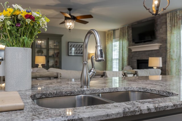 320 Manitoba Ln, Lexington, KY 40515 - kitchen with open floor plan, a sink, ceiling fan, and a fireplace
