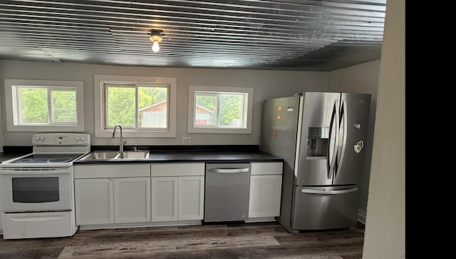 606 Prospect St, Berea, KY 40403 - kitchen featuring appliances with stainless steel finishes, a sink, dark countertops, white cabinetry, and dark wood-style flooring