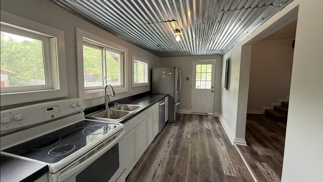606 Prospect St, Berea, KY 40403 - kitchen featuring appliances with stainless steel finishes, a sink, white cabinets, dark wood-style flooring, and baseboards