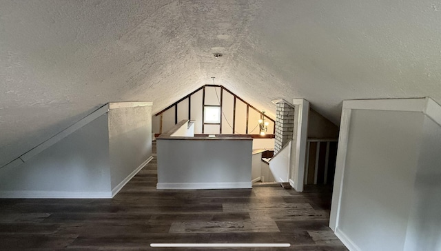 606 Prospect St, Berea, KY 40403 - additional living space with lofted ceiling, baseboards, wood finished floors, and a textured ceiling