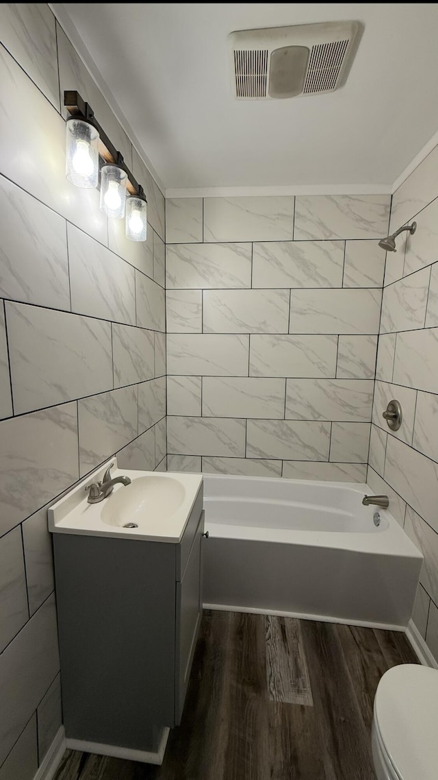 606 Prospect St, Berea, KY 40403 - bathroom featuring toilet, vanity, wood finished floors, and  shower combination