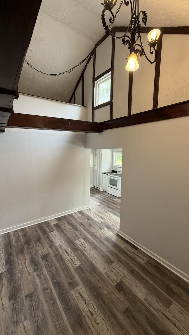 606 Prospect St, Berea, KY 40403 - interior space featuring a chandelier, high vaulted ceiling, dark wood-style floors, and baseboards