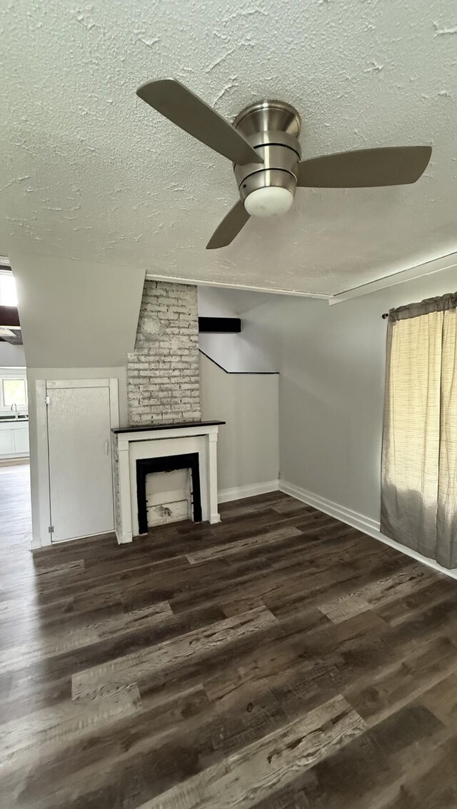 606 Prospect St, Berea, KY 40403 - unfurnished living room with ceiling fan, a textured ceiling, vaulted ceiling, wood finished floors, and a fireplace